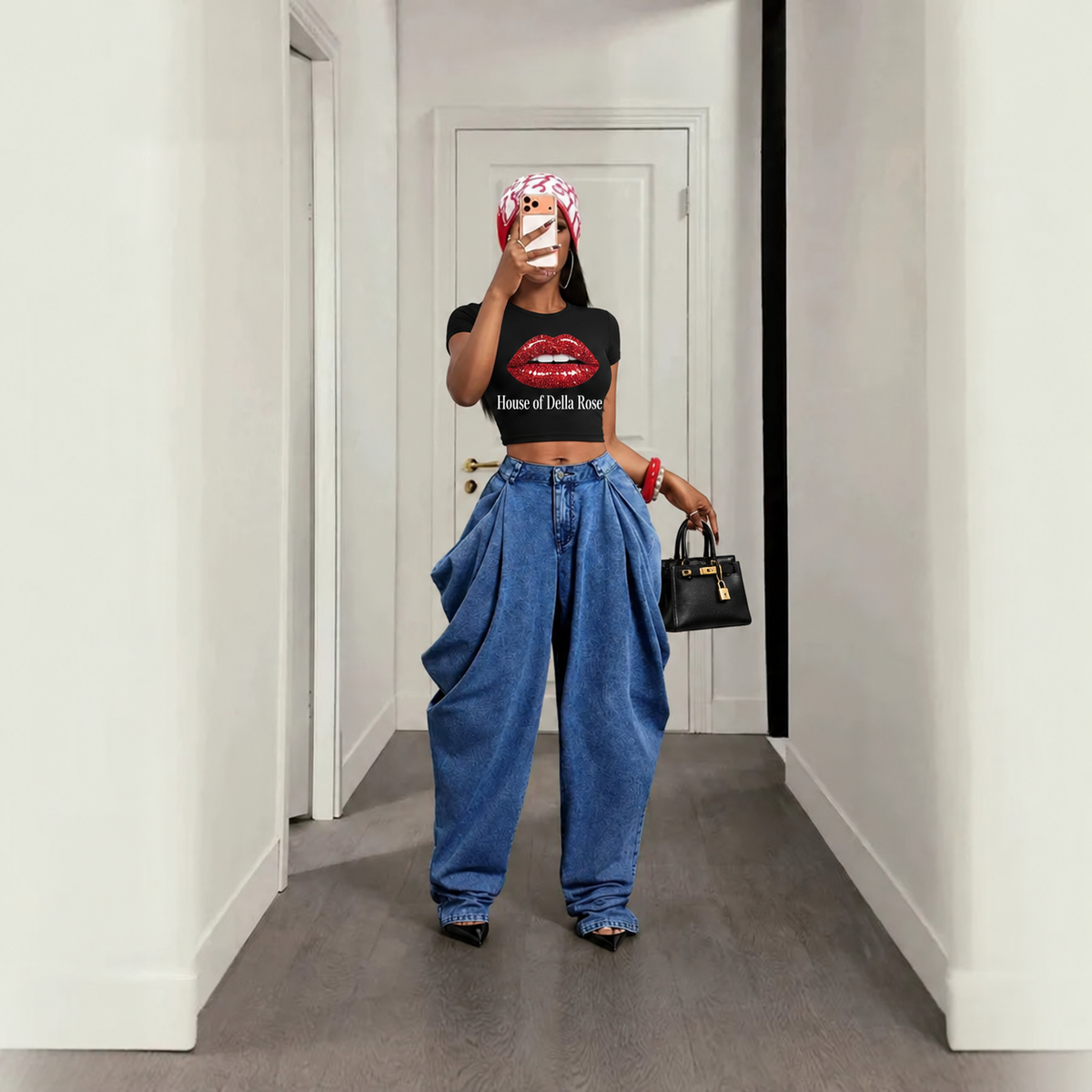Original model wearing blue pleated jeans, House of Della Rose glitter-lips tee, black heels and black purse